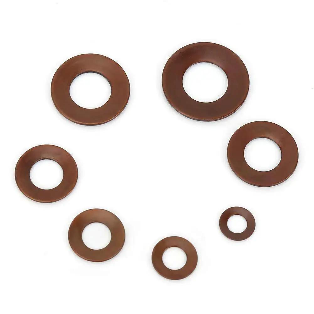 Various sizes of stainless steel Belleville disc springs for heavy loads and shock absorption on a white background.