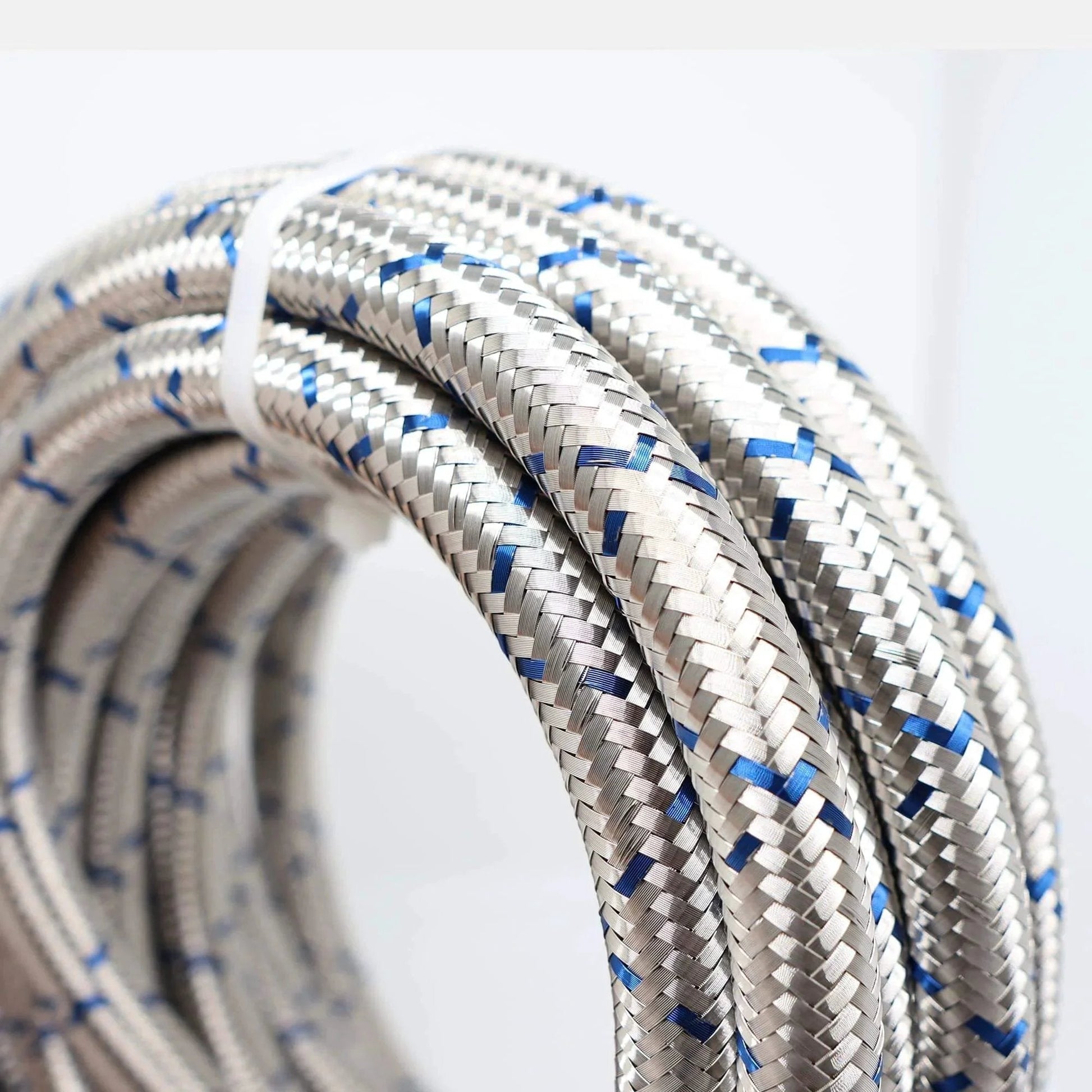 Close-up of Three Eighth Inch Stainless Steel Braided Fuel Line Hose E85 Compatible Kit with 30 Feet Length, highlighting braided detail.
