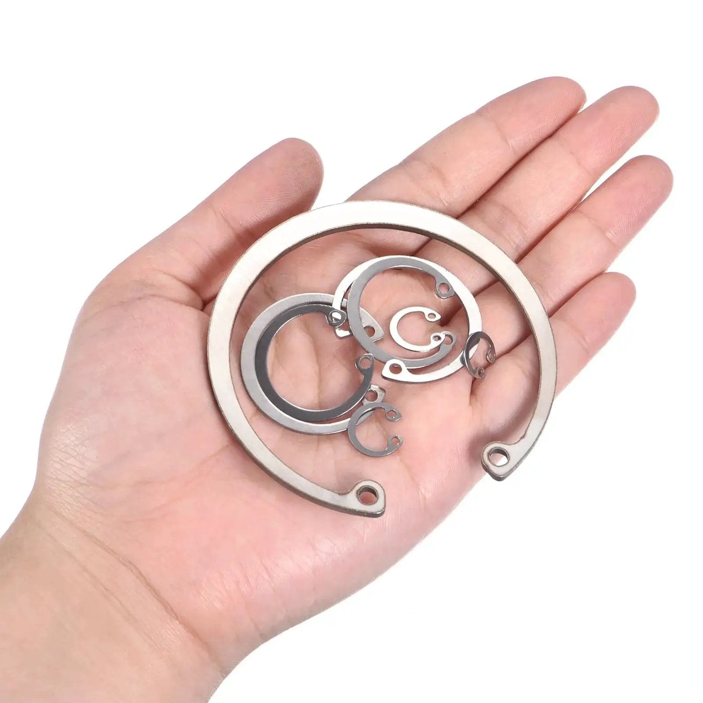 Hand holding Heavy Duty Internal Retaining Ring Circlip for Grooved Shafts and Studs 2 Pack by Uxcell 304 Stainless Steel