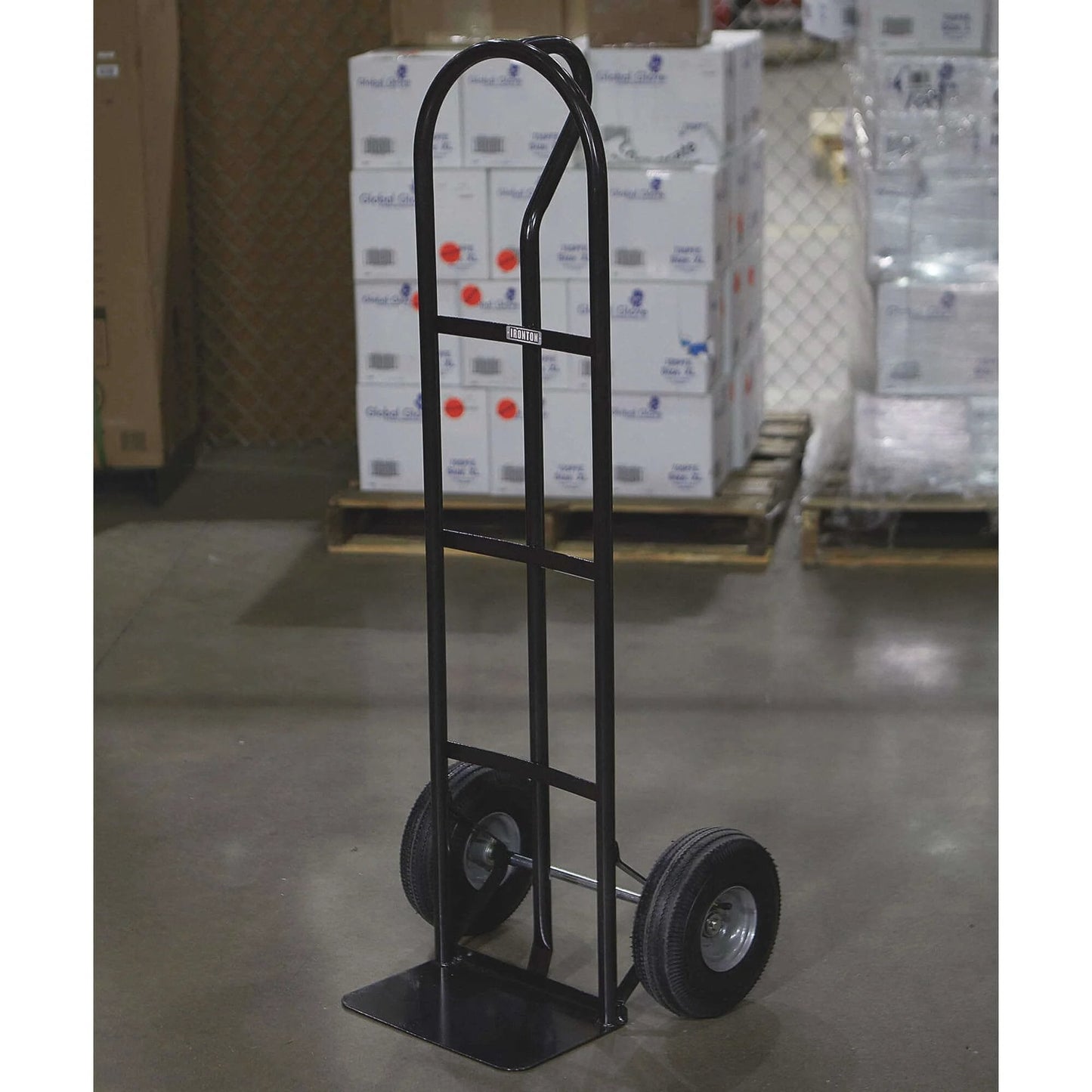 Steel Pneumatic Hand Truck Dolly - 600-Lb. Capacity, 10in. Tires, Powder-Coat Finish standing on warehouse floor.
