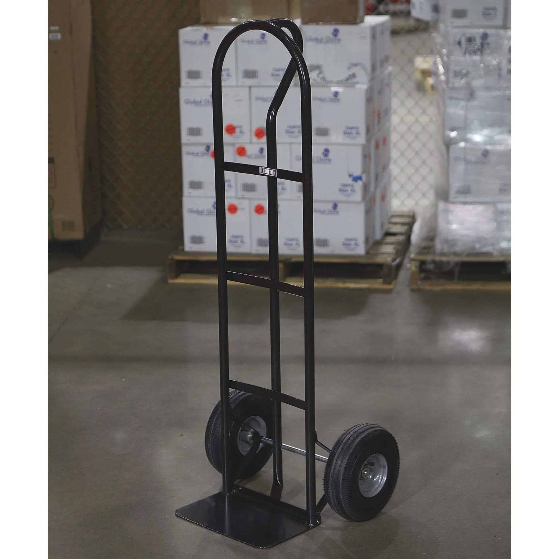 Steel Pneumatic Hand Truck Dolly - 600-Lb. Capacity, 10in. Tires, Powder-Coat Finish standing on warehouse floor.