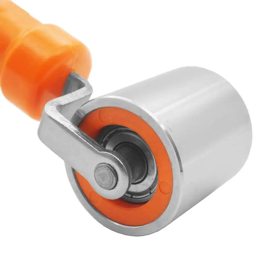 Close-up of Pro Grade Seam Roller Hand Roller with anti-slip ergonomic steel roller for wallpaper, vinyl, and car audio installations.