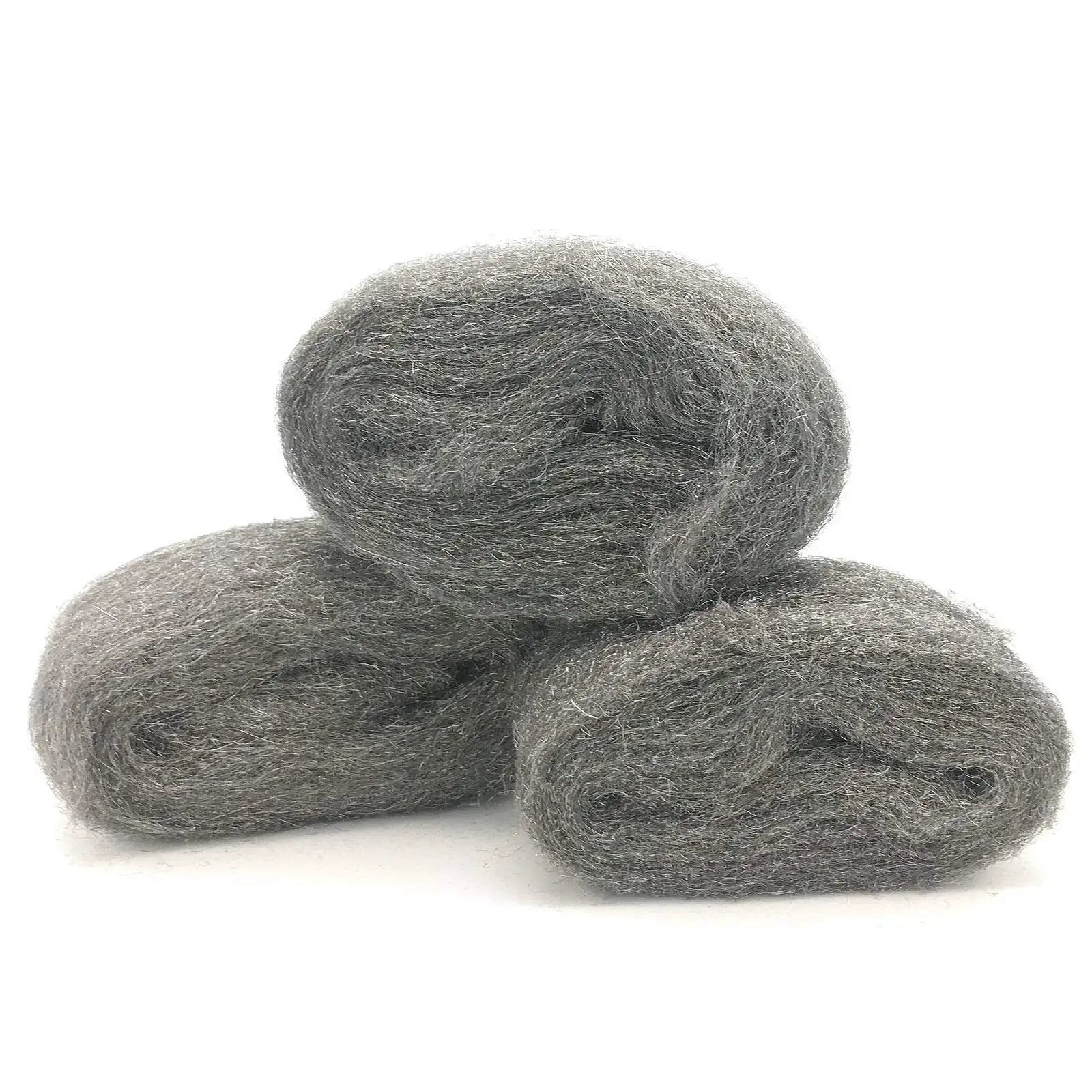 Three rolls of coarse steel wool fill fabric for mouse proofing homes displaying texture