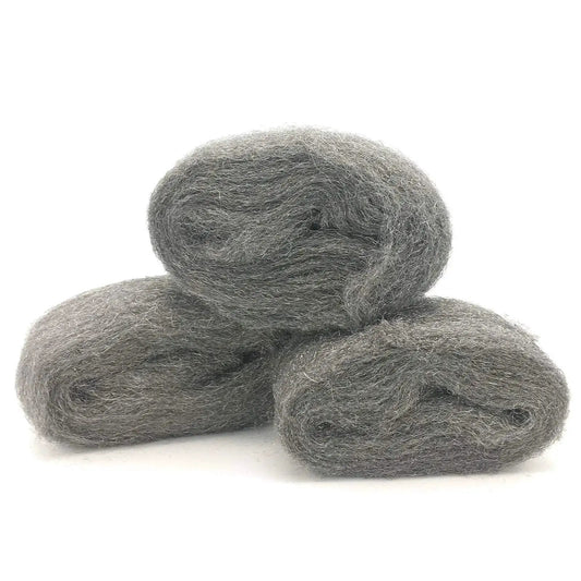 Three rolls of coarse steel wool fill fabric for mouse proofing homes displaying texture