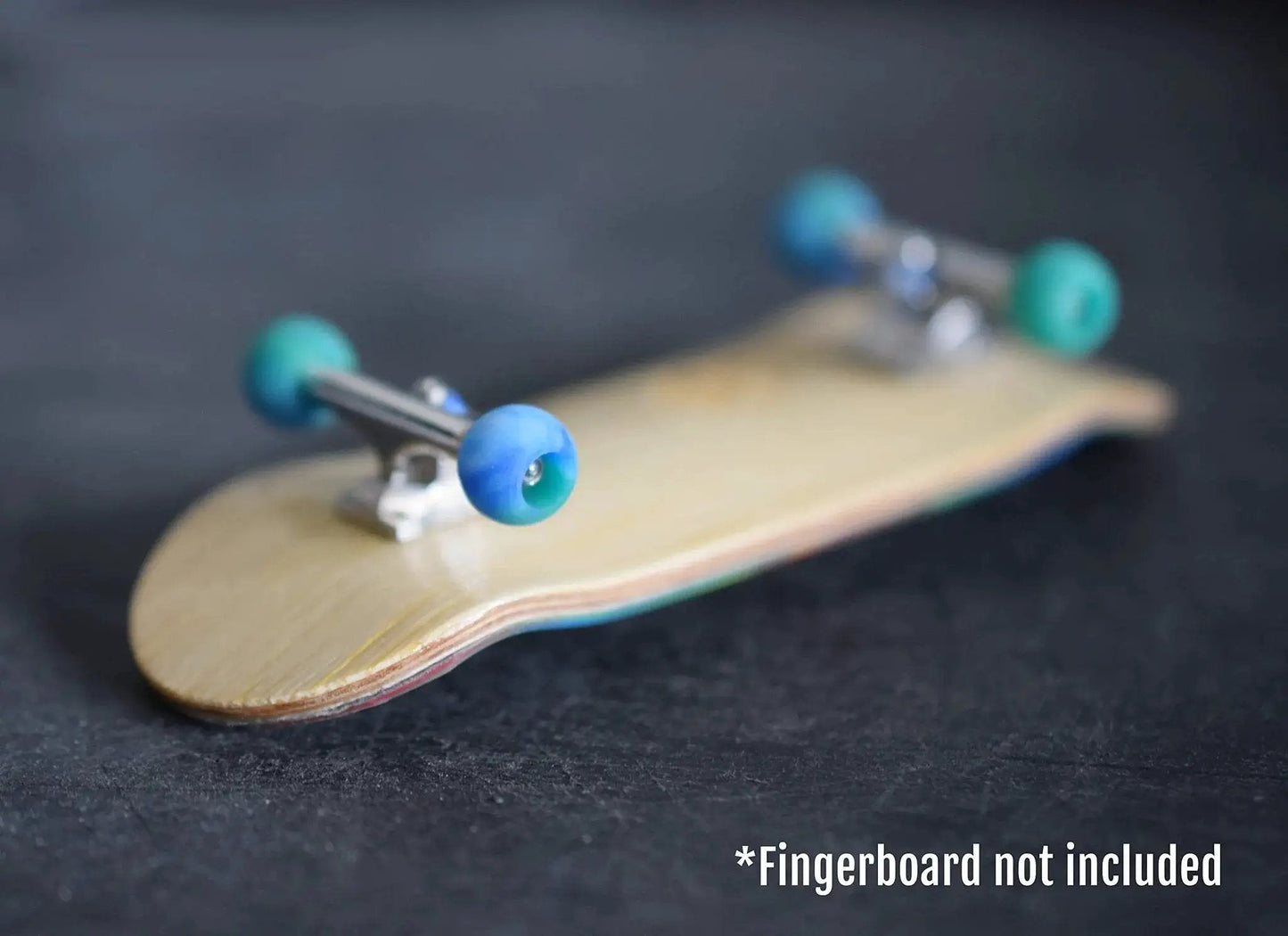 Apex 61D Urethane Fingerboard Wheels Globe Shape Terra Colorway installed on fingerboard, showing side view with ABEC-9 bearings.