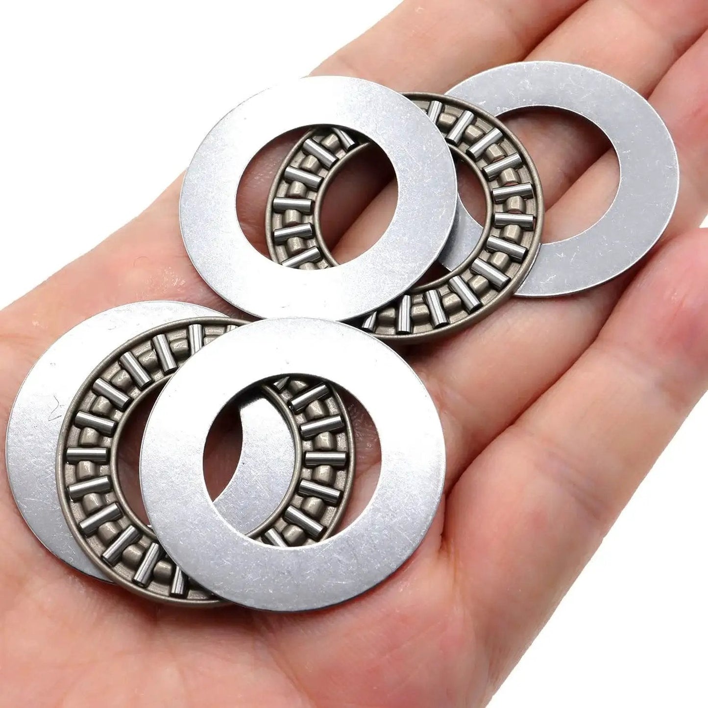 Heavy Duty Workhorse Thrust Needle Roller Bearing Set With Washers AXK2035 displayed on a hand, showcasing precision steel cage.