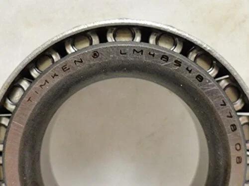 Close-up of TIMKEN LM48548 Tapered Roller Bearing showing engraved part number and internal rollers.