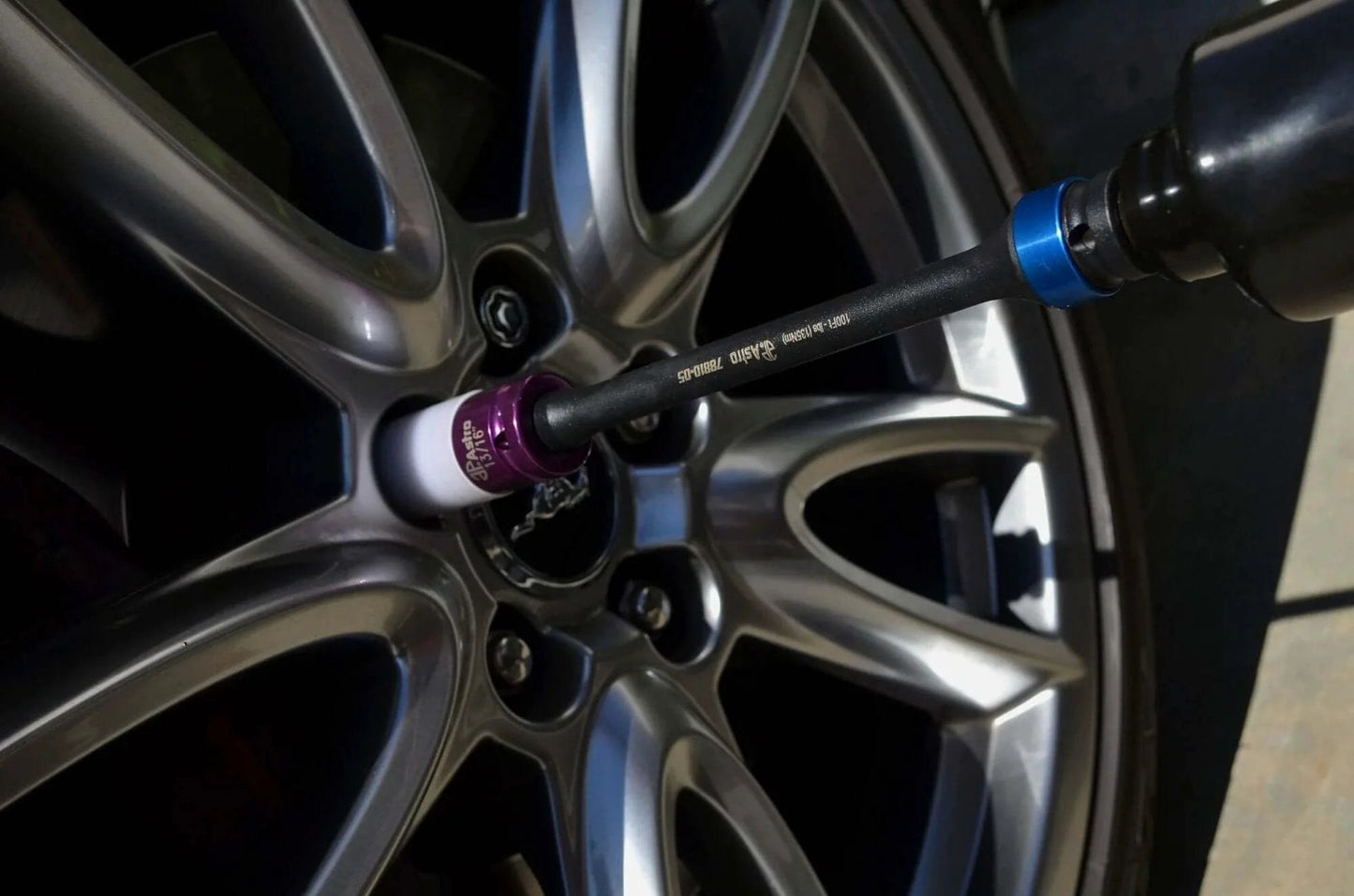 10-Piece Torque Limiting Extension Set in use on car wheel, displaying chrome molybdenum extension for accurate nut torque.