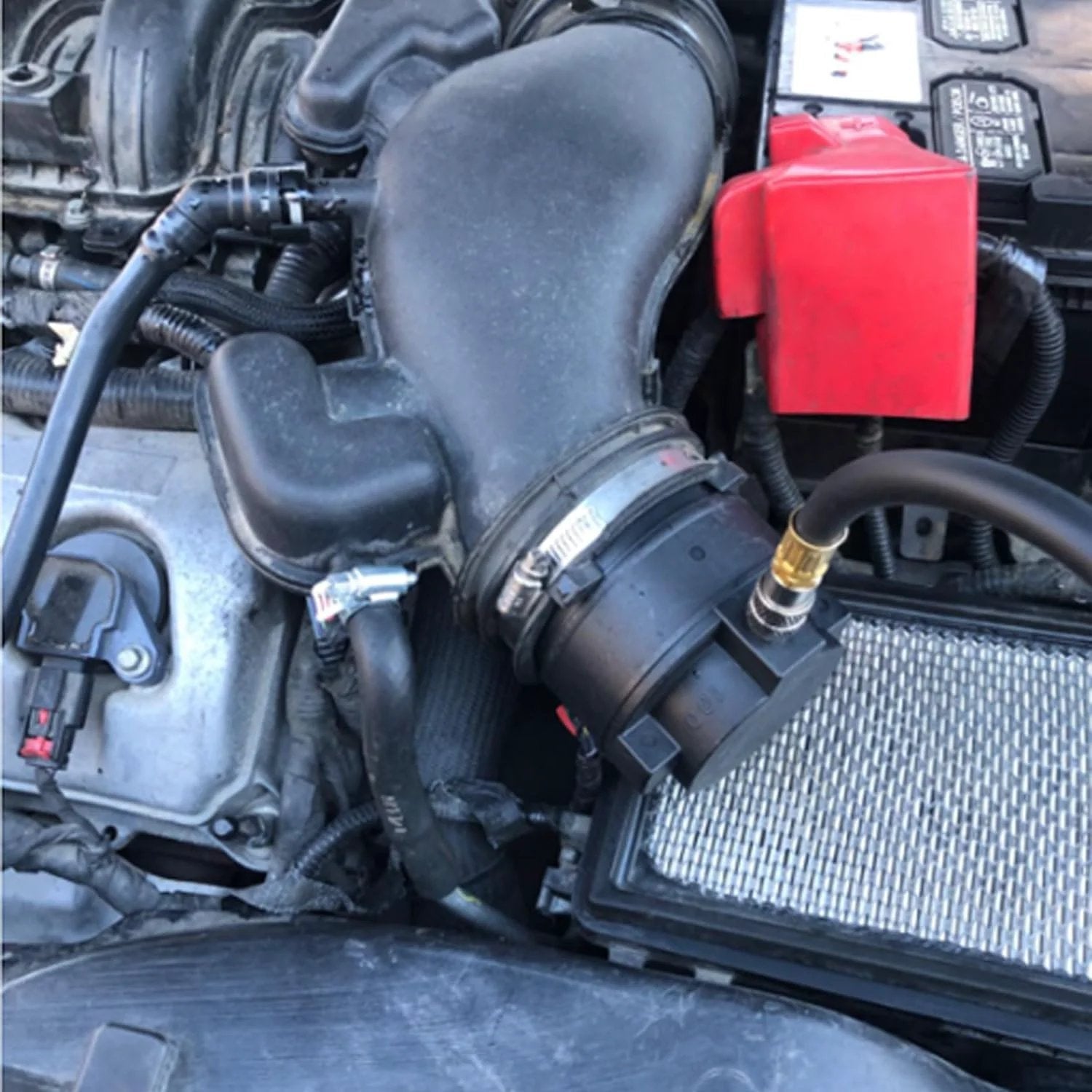 Turbo System Leakage Tester Kit With 19 Pieces For Turbochargers And Intercoolers Includes 16 Stepped Adapters From One And A Quarter Inch To Four And A Quarter Inch Plus Turbo Boost Pressure Gauge Radiator And Cooling System Leak Test Tools DPTOOL installed on a car engine.