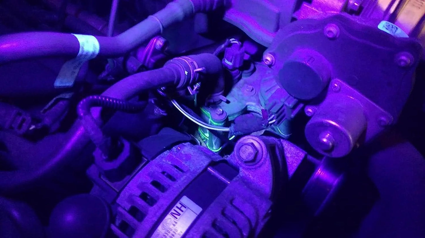 Pro Grade AC UV Dye Leak Detector Kit With 68 LED UV Flashlight And Protective Glasses, showing UV dye highlighting a potential leak in an auto engine.