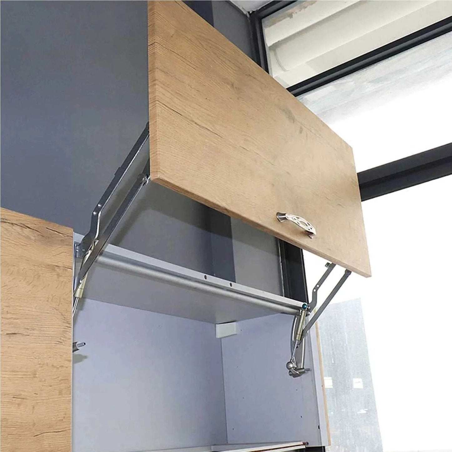 Vertical Swing Lift Up Stay Pneumatic for Cabinet Door installed, showcasing silver hinges and smooth arm mechanism in a kitchen cabinet.