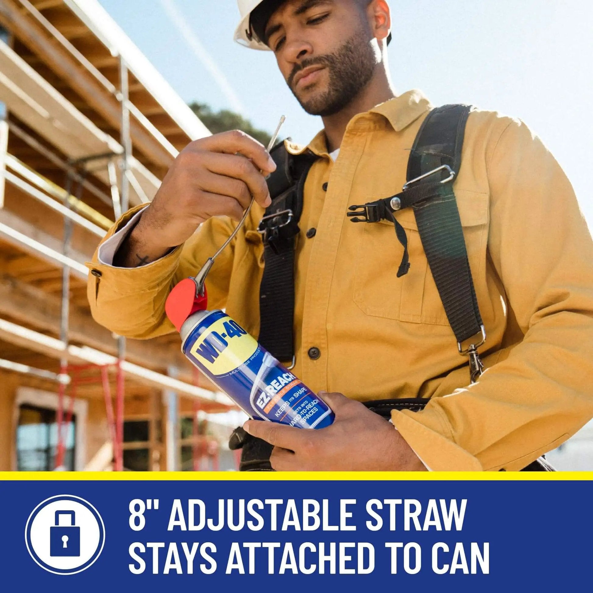 Worker holding EZ Reach Flexible Straw Multi Use Lubricant For Tight Spaces By WD-40 14.4 Oz Spray Can With 8 Inch Straw at a construction site