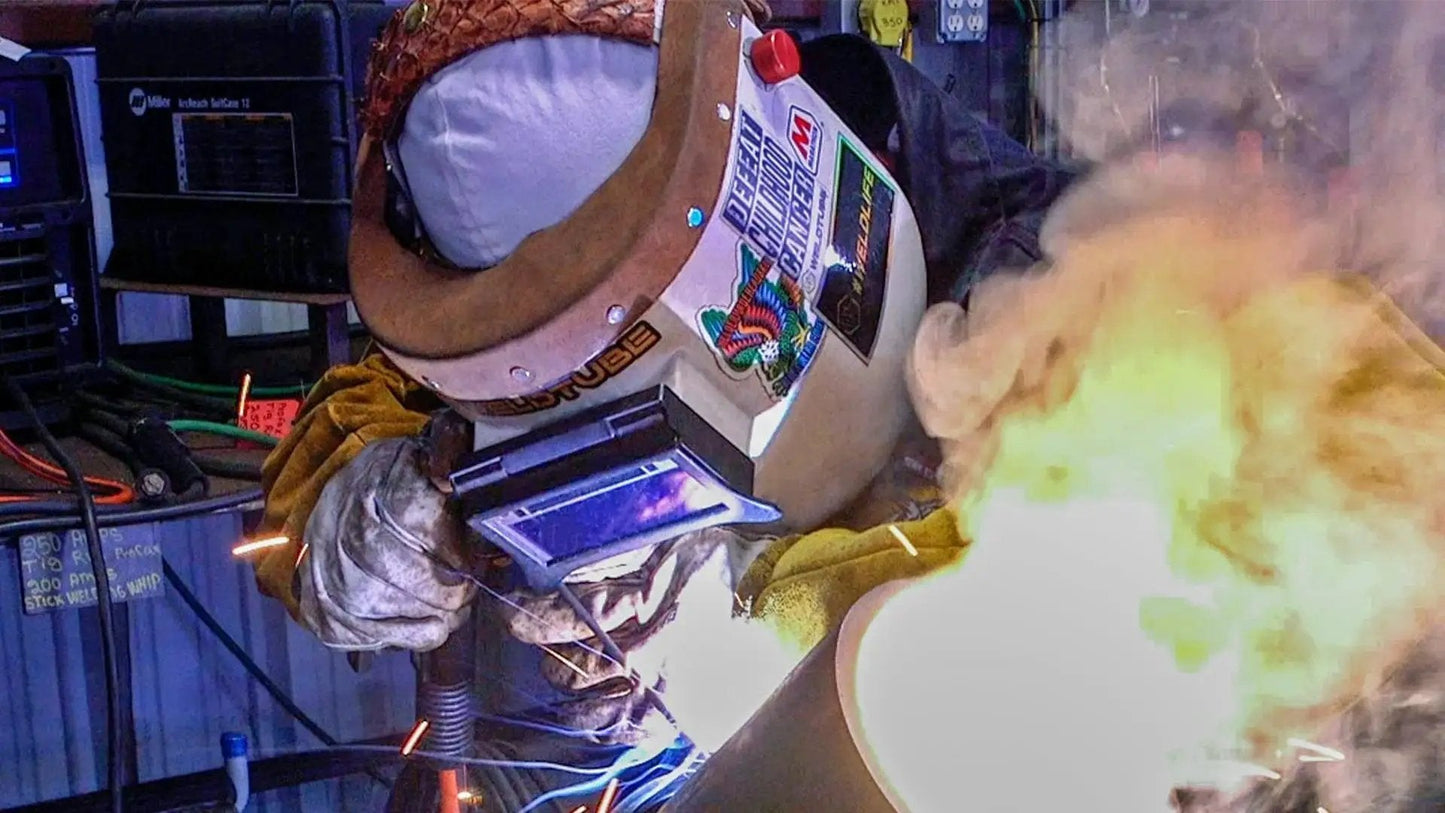 Welder using Flip Front Clip On Adapter for Pipeliner welding helmet, showcasing the quick attach shield in action during a metalwork task.