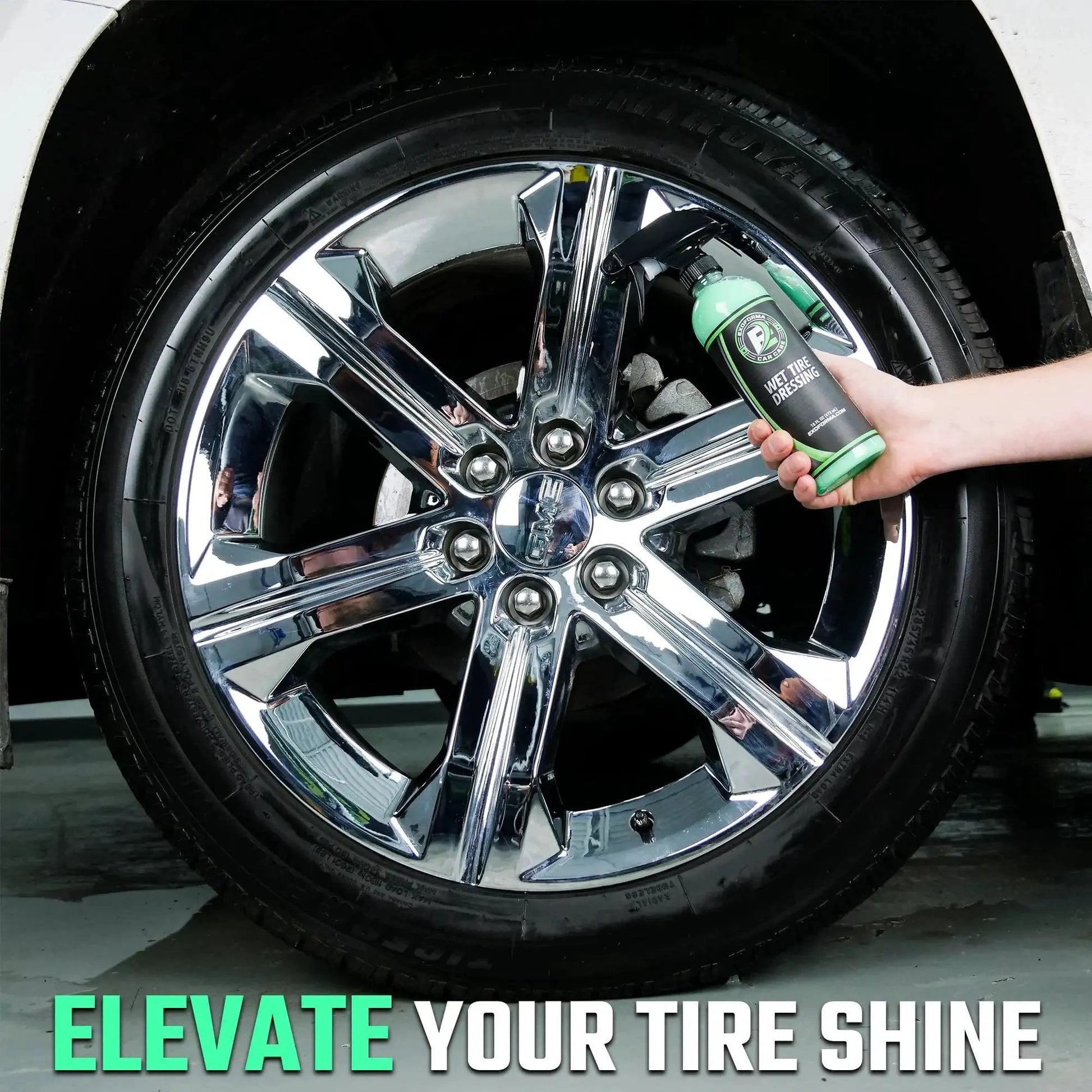 Hand holding Ultra Wet Tire Dressing Spray Delivers Extreme Shine With Non Greasy Silicone Formula near shiny car wheel.