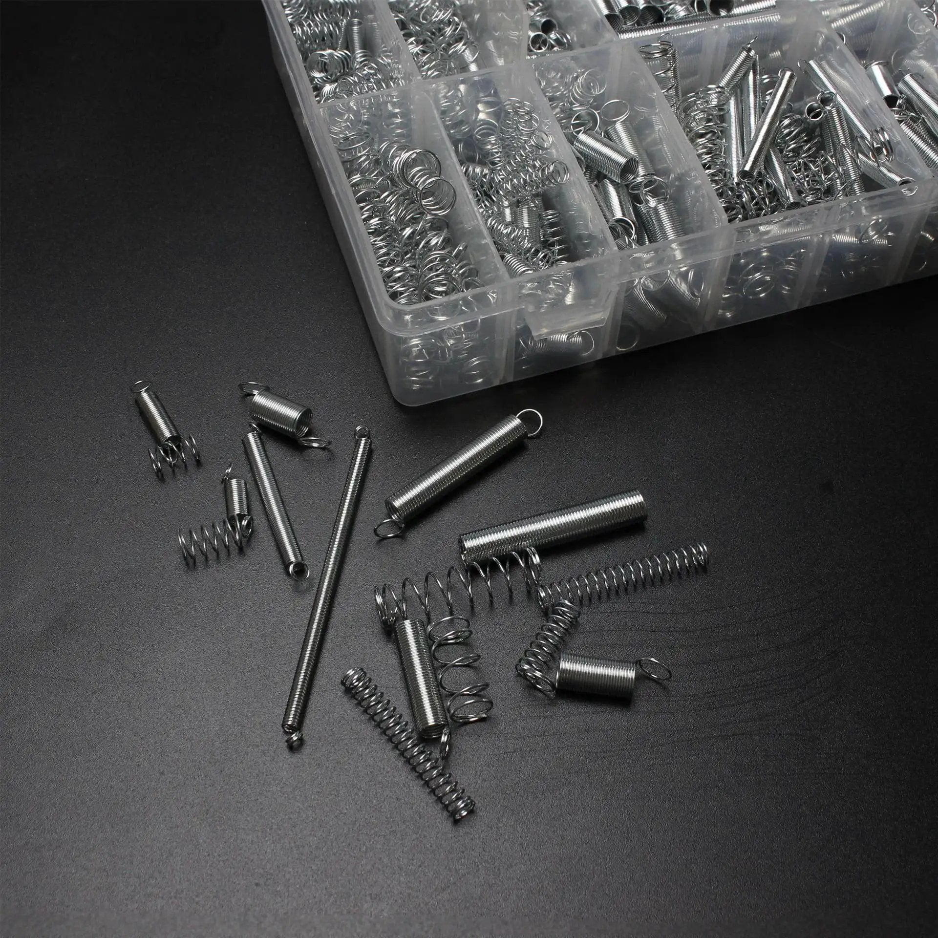 Spring Bundle Kit With 400 Pieces Across 20 Sizes Of Compression And Extension Springs Zinc Plated Steel For Durability Perfect For Appliances Toys Automotive Doors And DIY Repairs Projects, shown with case and assorted springs on black surface.